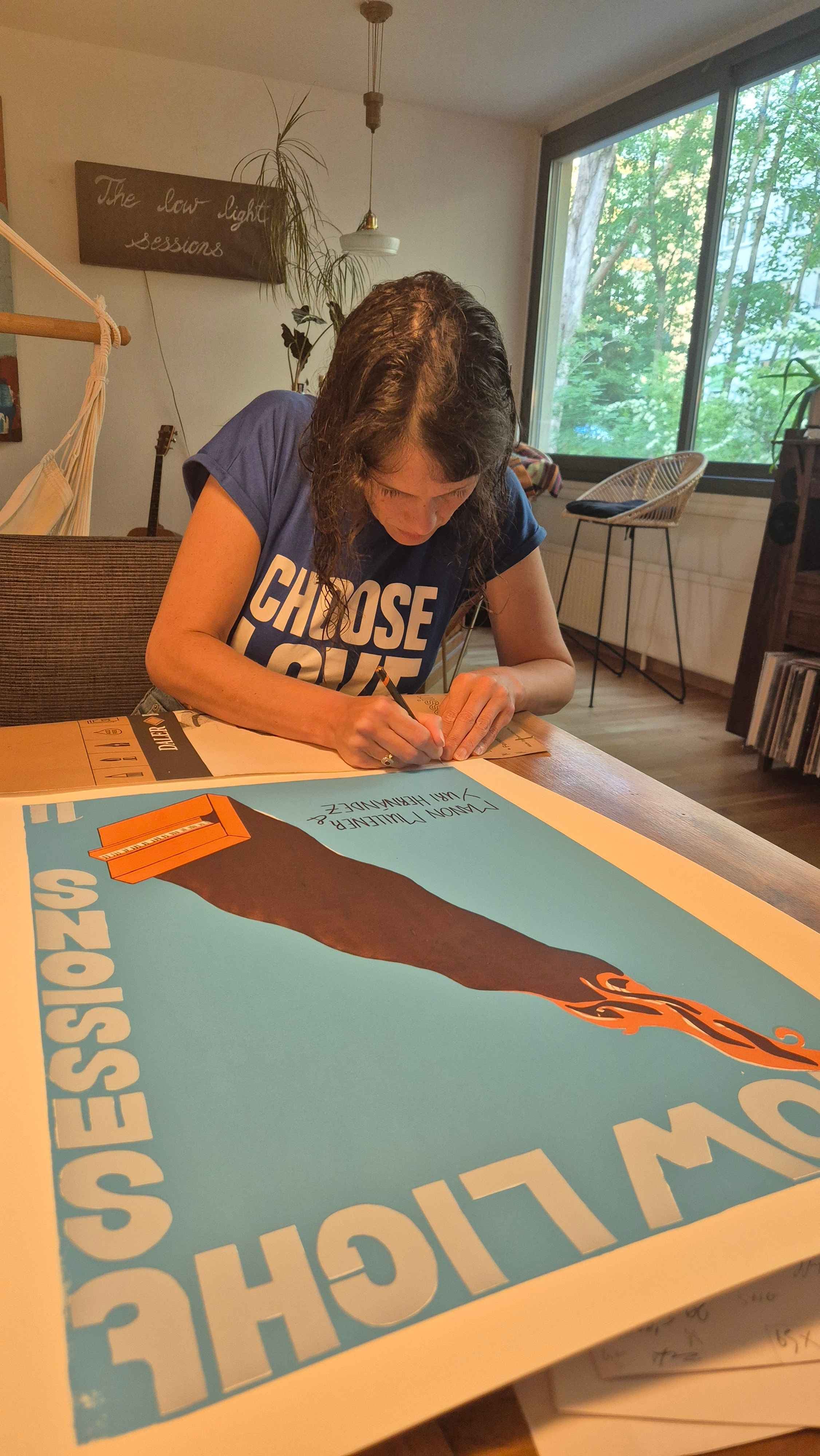A hand-painted Low Light Sessions poster by Claire
